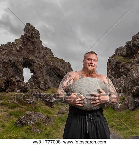 Strong man holding heavy stones, Djupalonssandur, Snaefellsnes Peninsula, Iceland View Large Photo Image Stock Photo - Strong man holding heavy stones, Djupalonssandur, Snaefellsnes Peninsula, Iceland. Fotosearch
