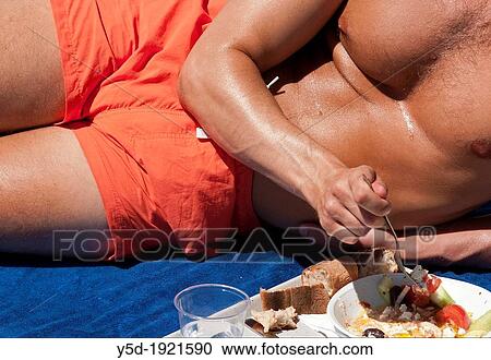 Strong man in good shape eating vegetarian salad View Large Photo Image Stock Image - Strong man in good shape eating vegetarian salad. Fotosearch