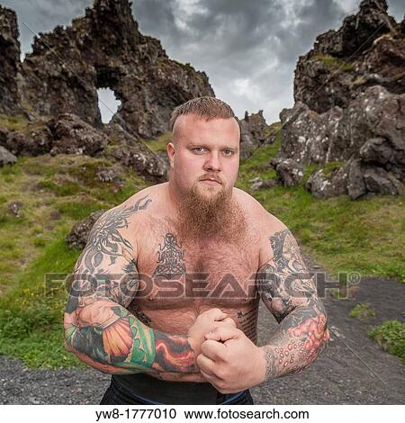 Strong man with Tattoos, Djupalonssandur, Snaefellsnes Peninsula, Iceland View Large Photo Image Stock Image - Strong man with Tattoos, Djupalonssandur, Snaefellsnes Peninsula, Iceland. Fotosearch