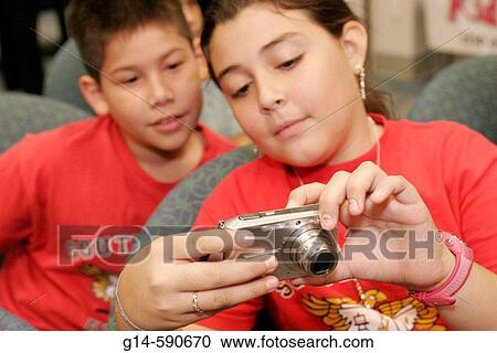 Stock Image - Student, entrepreneur, Hispanic boy, girl, camera. KidVentures. Royal Caribbean Headquarters. Miami. Florida. USA.. Fotosearch