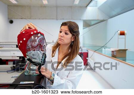 Stock Image - Student in the Biomedical Instrumentation Laboratory, Cap for realization of Electroencephalogram, Biomedical Engineering, CEIT (Center of Studies and Technical Research), University of Navarra, Donostia, Gipuzkoa, Basque Country, Spain. Fotosearch