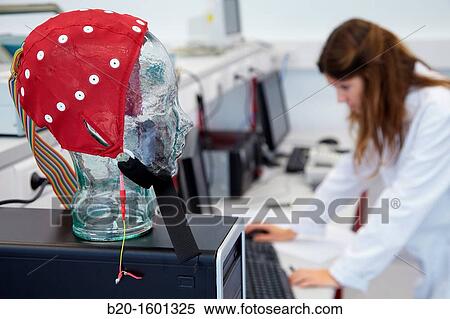 Stock Photography - Student in the Biomedical Instrumentation Laboratory, Cap for realization of Electroencephalogram, Biomedical Engineering, CEIT (Center of Studies and Technical Research), University of Navarra, Donostia, Gipuzkoa, Basque Country, Spain. Fotosearch
