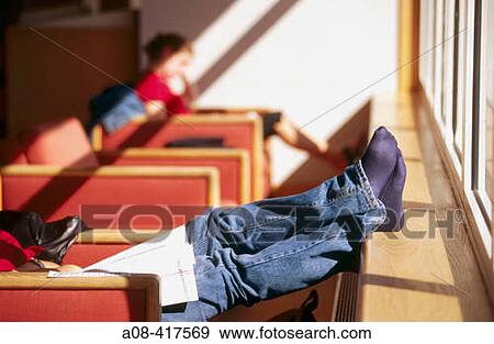 Student reads and relaxes at college library. Pennsylvania, USA View Large Photo Image Stock Photo - Student reads and relaxes at college library. Pennsylvania, USA. Fotosearch