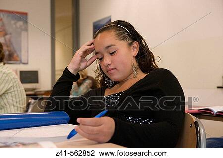 Stock Image - Student sitting in the classroom. Fotosearch
