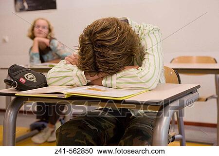Stock Image - Student sleeping in the classroom. Fotosearch