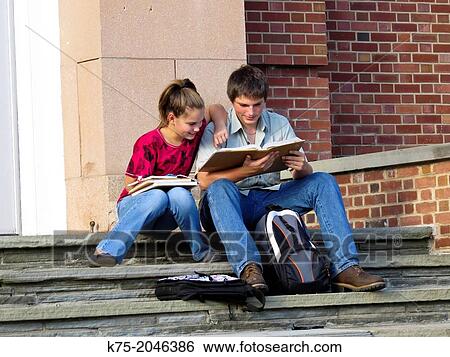 Stock Photograph - Students helping each other with homework. Fotosearch