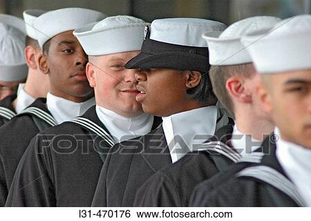 Stock Photograph - Students in the Navy Navel ROTC corps marching with the flags. Fotosearch