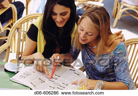 Stock Photograph - Students looking at classified ads. Fotosearch