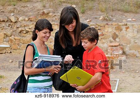 Stock Photograph - Students taking a lesson outside Roman ruins. Fotosearch