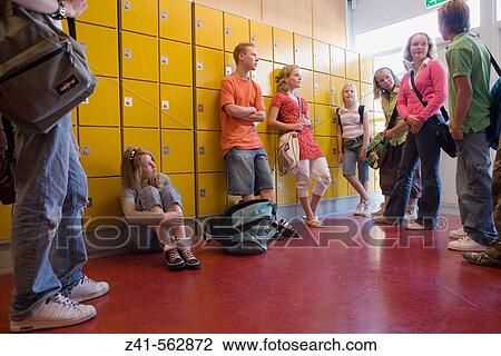 Stock Image - Students talking in the hallway.. Fotosearch
