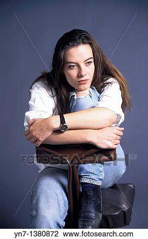 studio image of a teenage girl sitting with her chin on her knee day dreaming View Large Photo Image Stock Image - studio image of a teenage girl sitting with her chin on her knee day dreaming. Fotosearch
