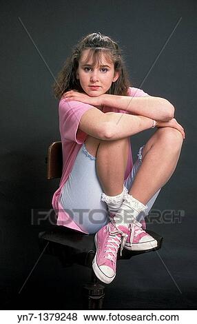 Stock Photo - studio image of teenage girl dressed in candy pink 50s style. Fotosearch