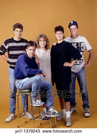 Stock Image - Studio portrait of a group of five happy teenagers in casual clothes. Fotosearch