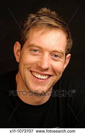 Studio portrait of a happy smiling confident healthy blue-eyed 30 year old British man View Large Photo Image Stock Photo - Studio portrait of a happy smiling confident healthy blue-eyed 30 year old British man. Fotosearch
