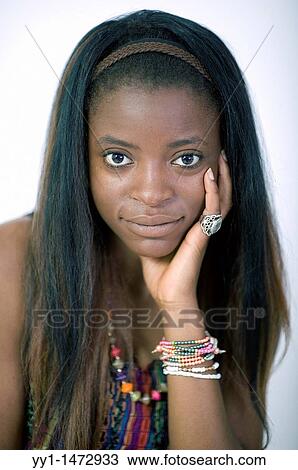 Stock Image - Studio portrait of a young negress teenager with bracelets.. Fotosearch