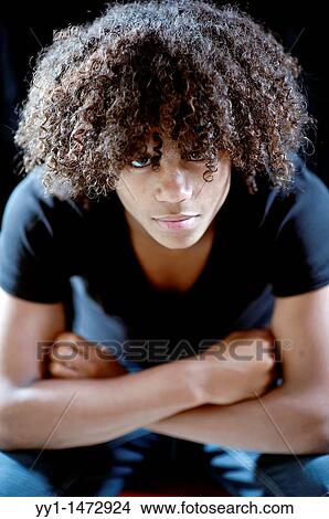 Studio-portrait of a young, dark-skinned teenager with frizzy hair. View Large Photo Image Picture - Studio-portrait of a young, dark-skinned teenager with frizzy hair.. Fotosearch
