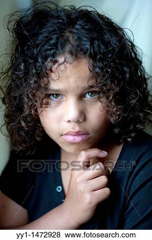 Studio-portrait of a young, dark-skinned teenager with curly hear. View Large Photo Image Stock Photo - Studio-portrait of a young, dark-skinned teenager with curly hear.. Fotosearch