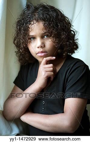 Studio-portrait of a young, dark-skinned teenager with curly hear. View Large Photo Image Stock Photo - Studio-portrait of a young, dark-skinned teenager with curly hear.. Fotosearch