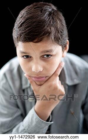Stock Photograph - Studio-portrait of a young, dark-skinned teenager.. Fotosearch