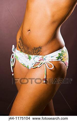 Studio portrait of black woman in swimming suit with a tattoo View Large Photo Image Picture - Studio portrait of black woman in swimming suit with a tattoo. Fotosearch