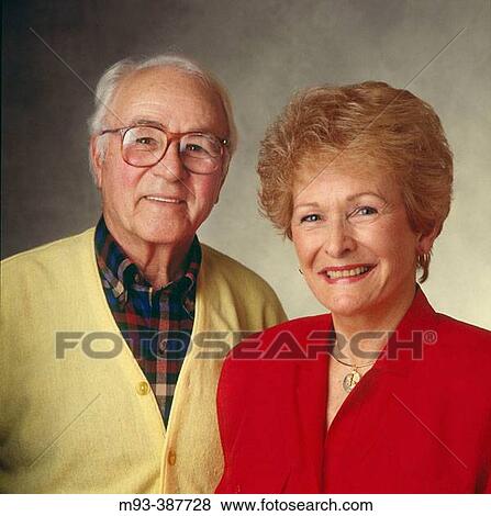 Studio portrait of pleasant looking retired couple. Man in yellow sweater and plaid shirt; woman in red top View Large Photo Image Stock Photo - Studio portrait of pleasant looking retired couple. Man in yellow sweater and plaid shirt; woman in red top. Fotosearch