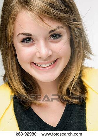 Stock Image - studio portrait of smiling 13 year old girl. Fotosearch