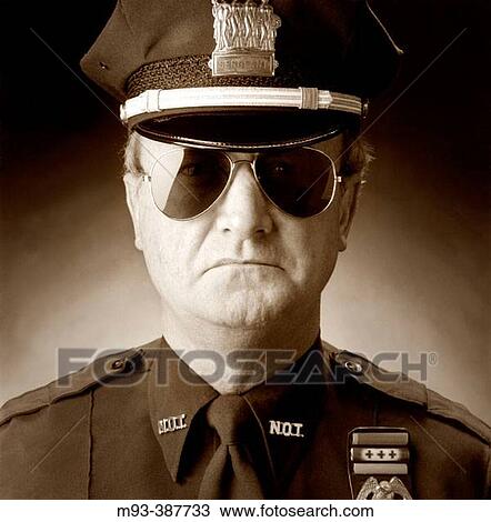 Studio portrait of stern-looking policeman in sunglasses View Large Photo Image Stock Image - Studio portrait of stern-looking policeman in sunglasses. Fotosearch