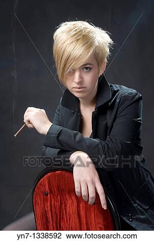 studio portrait of young blond woman with cigar View Large Photo Image Stock Image - studio portrait of young blond woman with cigar. Fotosearch