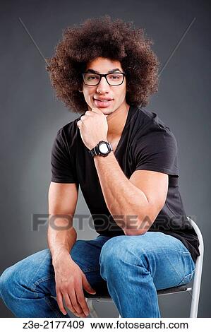 studio portrait of young man in front of gray background. View Large Photo Image Stock Photo - studio portrait of young man in front of gray background.. Fotosearch