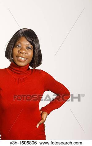 Stock Photograph - Studio shot of black woman, smiling. Fotosearch