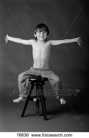 Studio shot of boy with outstretched arms and bare feet View Large Photo Image Stock Image - Studio shot of boy with outstretched arms and bare feet. Fotosearch