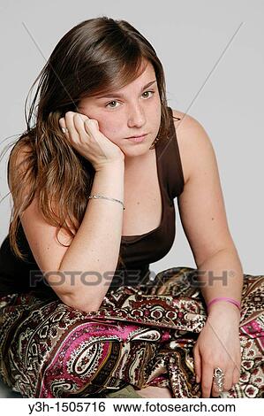 Stock Photograph - Studio shot of female teenager, bored. Fotosearch