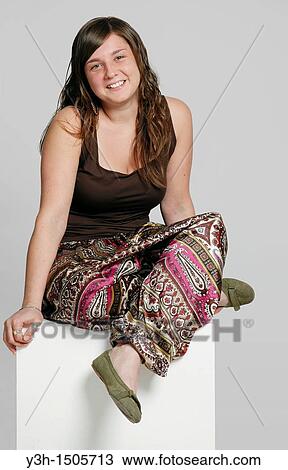 Studio shot of female teenager, smiling View Large Photo Image Stock Image - Studio shot of female teenager, smiling. Fotosearch