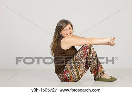 Stock Photo - Studio shot of female teenager, smiling. Fotosearch