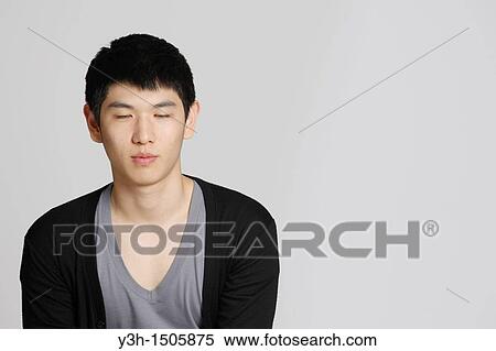Studio shot of Korean man, eyes closed View Large Photo Image Stock Photography - Studio shot of Korean man, eyes closed. Fotosearch