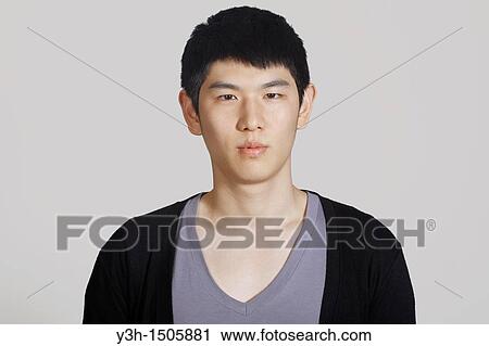Stock Image - Studio shot of Korean man, portrait. Fotosearch