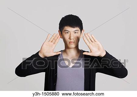 Studio shot of Korean man, showing hands View Large Photo Image Stock Image - Studio shot of Korean man, showing hands. Fotosearch