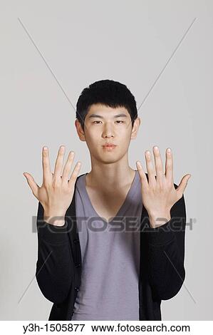 Studio shot of Korean man, showing hands View Large Photo Image Stock Photo - Studio shot of Korean man, showing hands. Fotosearch