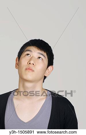 Stock Image - Studio shot of Korean man. Fotosearch