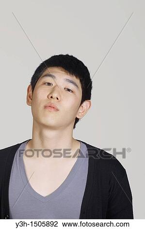 Stock Image - Studio shot of Korean man. Fotosearch