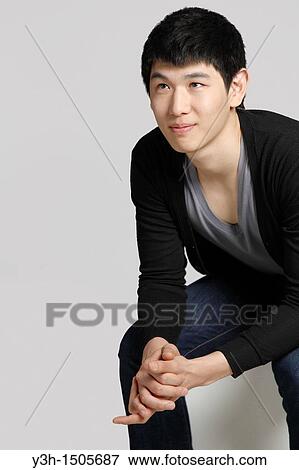 Stock Photo - Studio shot of Korean man. Fotosearch