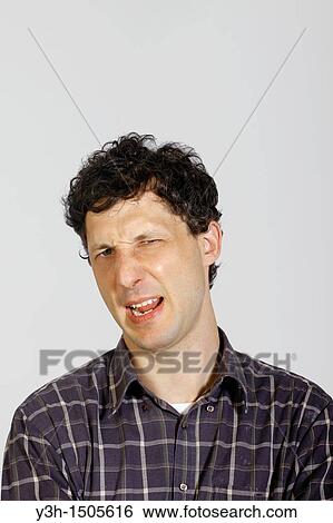 Studio shot of man, disgusted View Large Photo Image Stock Photograph - Studio shot of man, disgusted. Fotosearch