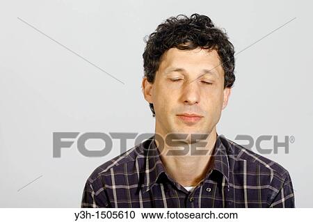 Stock Image - Studio shot of man, eyes closed. Fotosearch