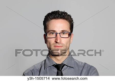 Studio shot of man, looking at camera View Large Photo Image Picture - Studio shot of man, looking at camera. Fotosearch