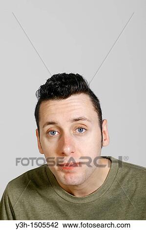 Stock Image - Studio shot of man, looking at camera. Fotosearch