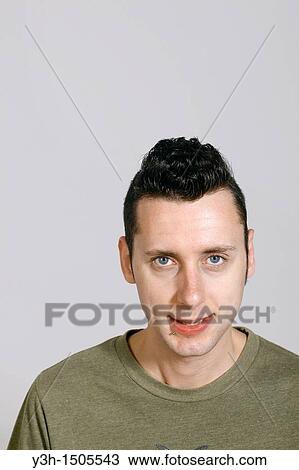 Studio shot of man, looking at camera View Large Photo Image Stock Image - Studio shot of man, looking at camera. Fotosearch