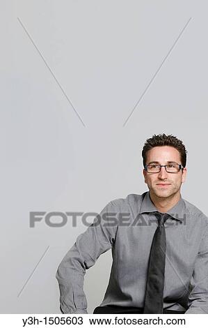 Stock Image - Studio shot of man, looking at camera. Fotosearch