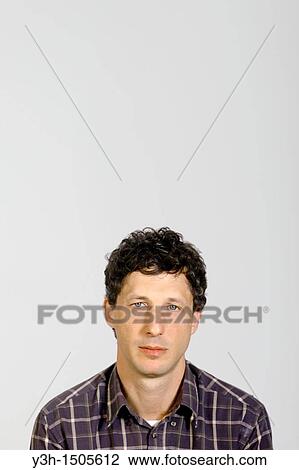 Studio shot of man, looking at camera View Large Photo Image Stock Image - Studio shot of man, looking at camera. Fotosearch
