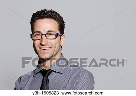 Stock Image - Studio shot of man, looking at camera. Fotosearch