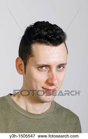 Studio shot of man, looking at camera View Large Photo Image Stock Photo - Studio shot of man, looking at camera. Fotosearch